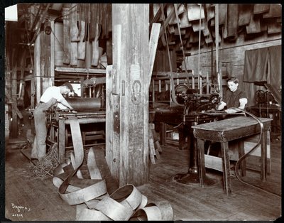 Interior view of men working with leather at the New York Leather Belting Co., New York, 1905 or 1906 by Byron Company